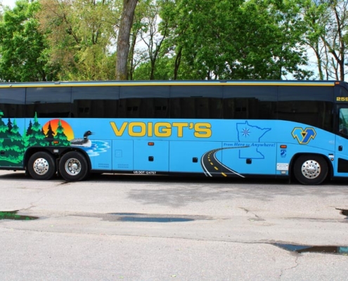Side view of a Voigt bus featuring a loon, Minnesota state outline, and other Minnesota elements