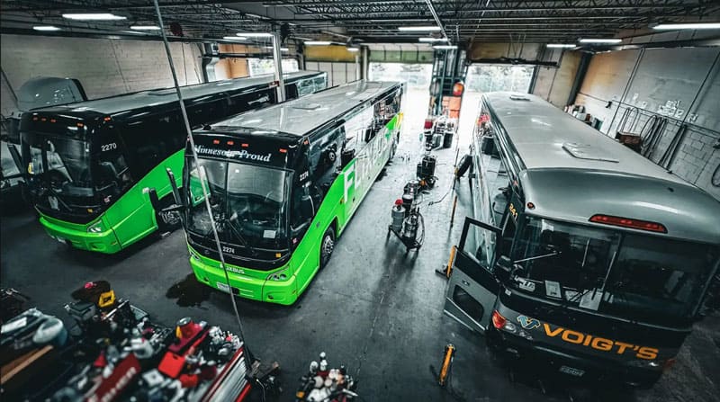 bus-repair Three buses are sitting in a bus repair garage.