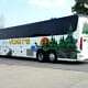 A Voigt’s charter bus is parked on the street.