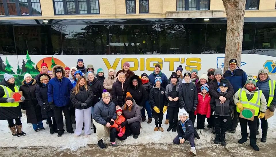 charter-party A tour group standing in front of a coach bus.