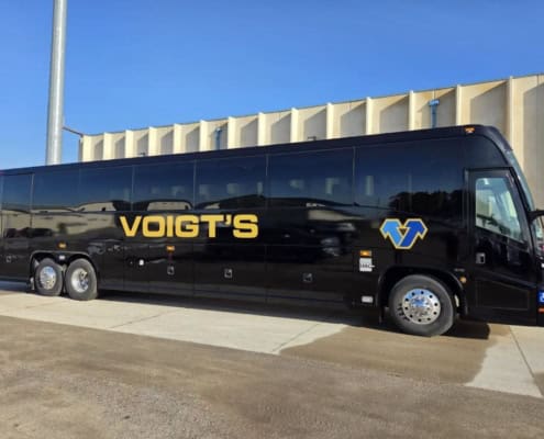 A large black charter bus from Voigt’s Bus Service.