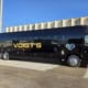 A large black charter bus from Voigt’s Bus Service.
