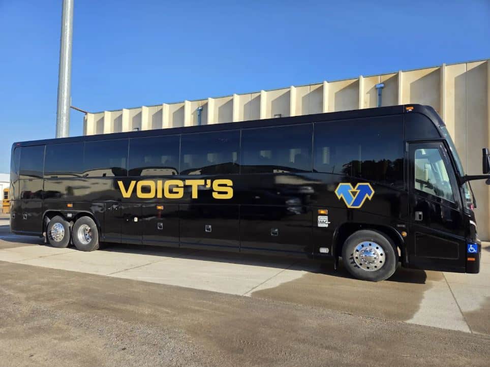 grouptravel A large black charter bus from Voigt’s Bus Service.