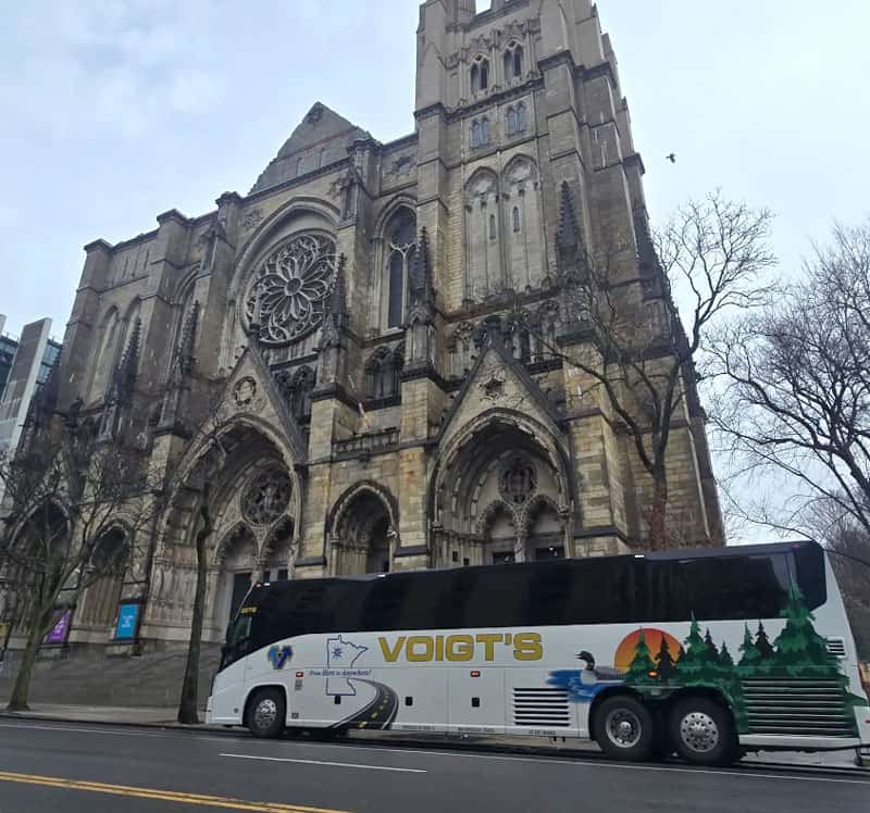 coach-trip A Voigt’s coach bus parked in front of a historic church.