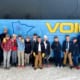 A youth hockey team posing in front of a Voigt’s charter bus.